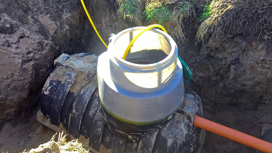 Plumbing drain pipe is being connected to septic tank for waste treatment
